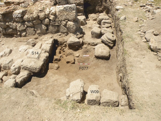 Fig. 7. Floor F077 and stone material collapsed from W08, viewed from the east.